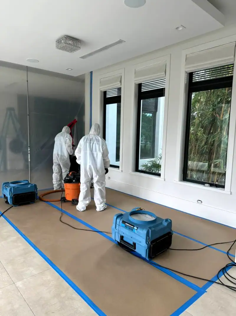 24/7 Service Pros technician inspecting water damage during a restoration job
