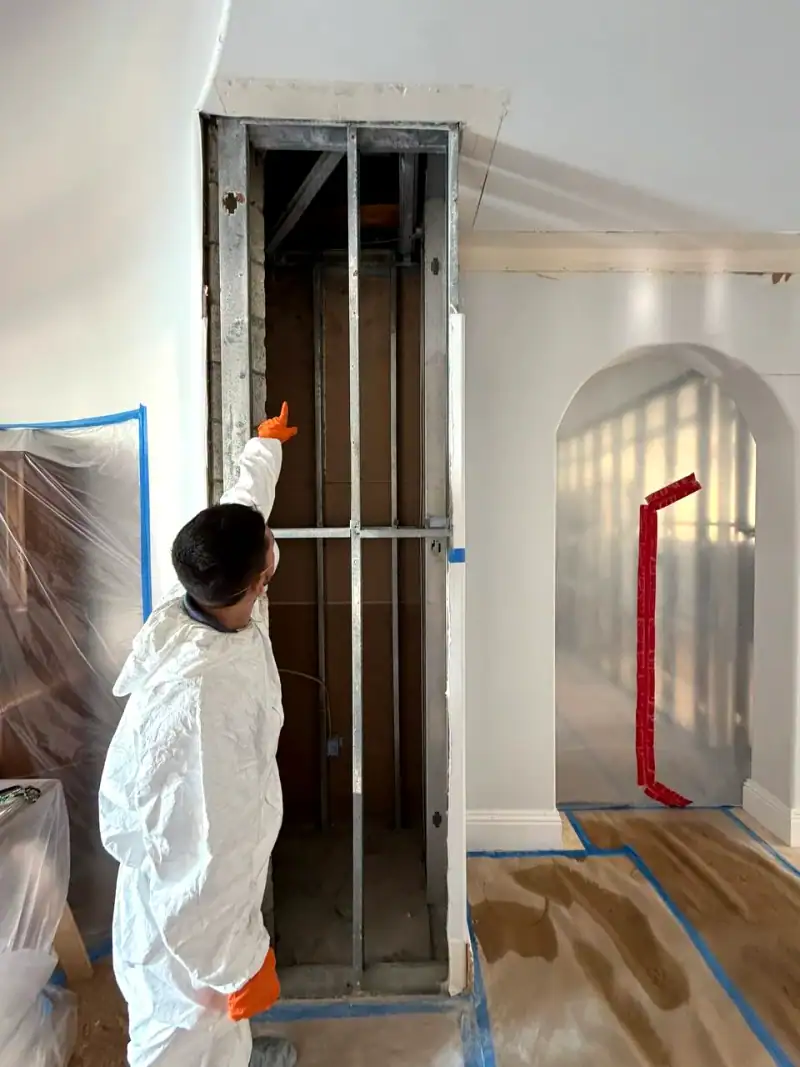 24/7 Service Pros technician inspecting water damage during a restoration job