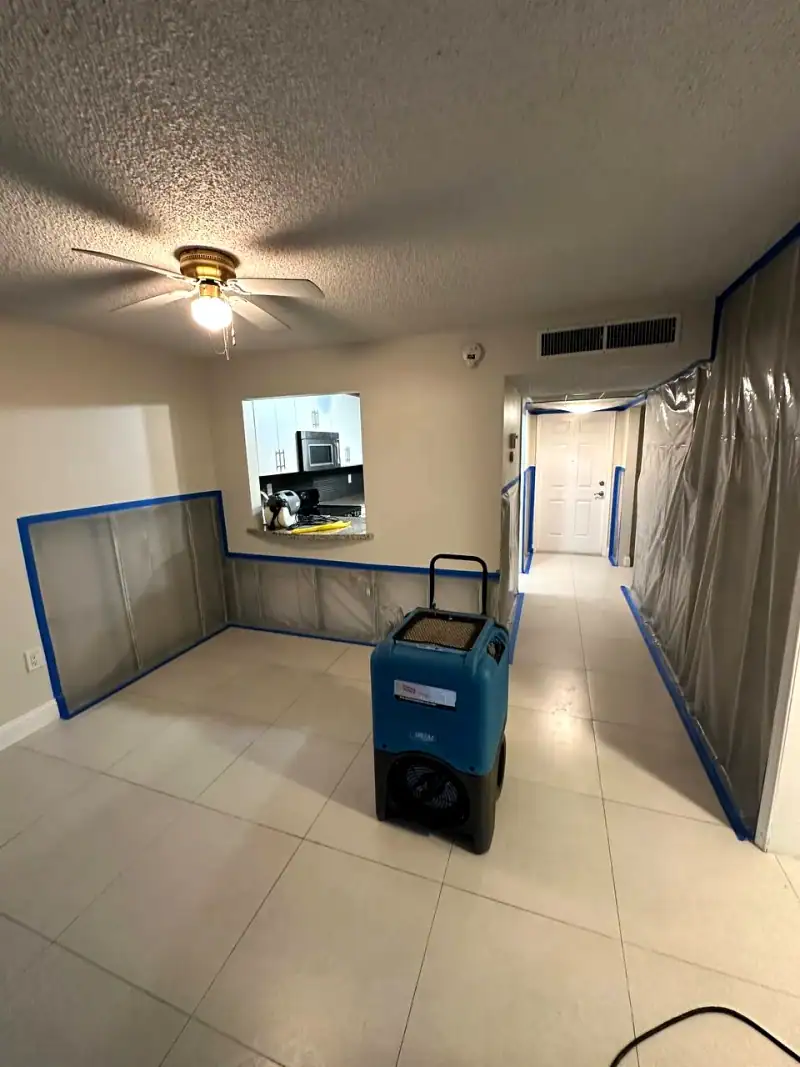24/7 Service Pros technician inspecting water damage during a restoration job