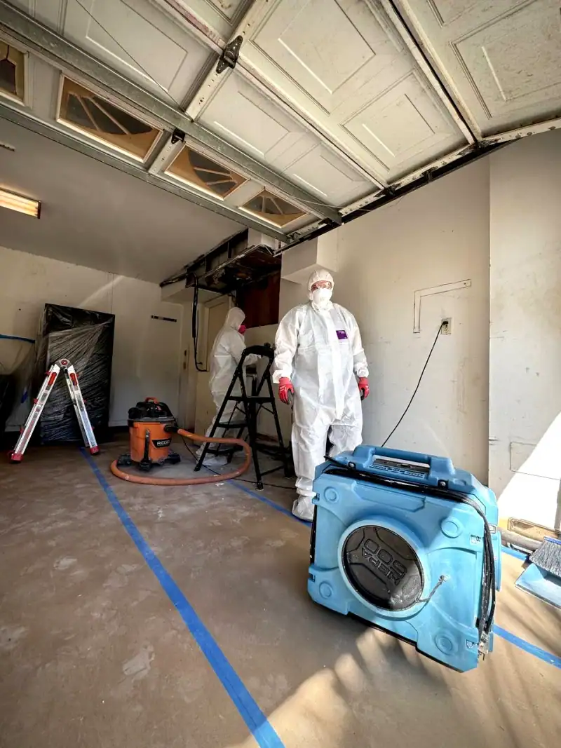 24/7 Service Pros technician inspecting water damage during a restoration job
