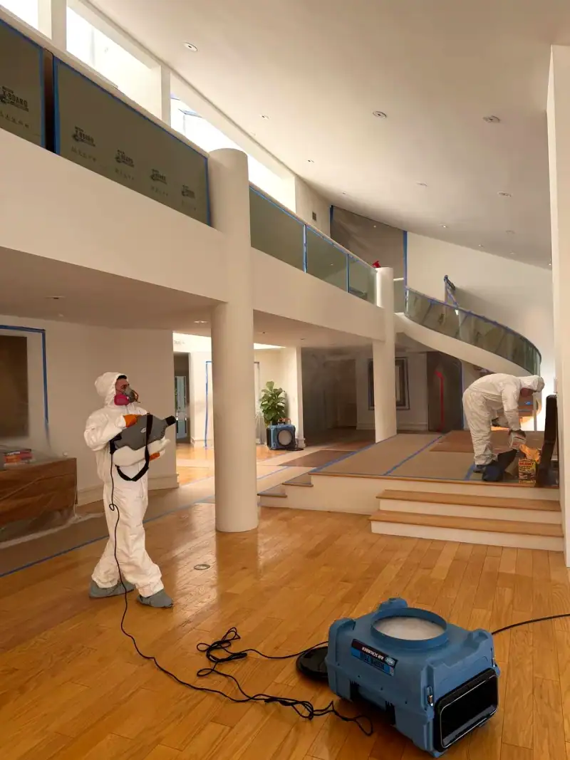 24/7 Service Pros technician inspecting water damage during a restoration job