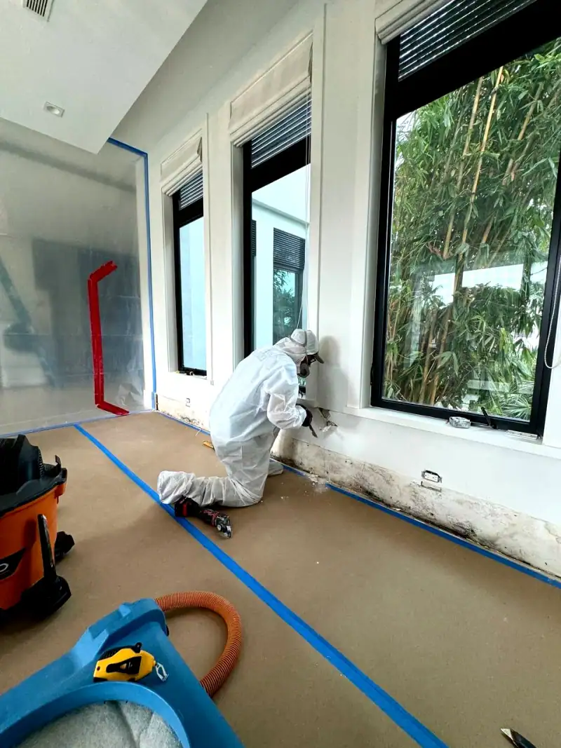 24/7 Service Pros technician inspecting water damage during a restoration job