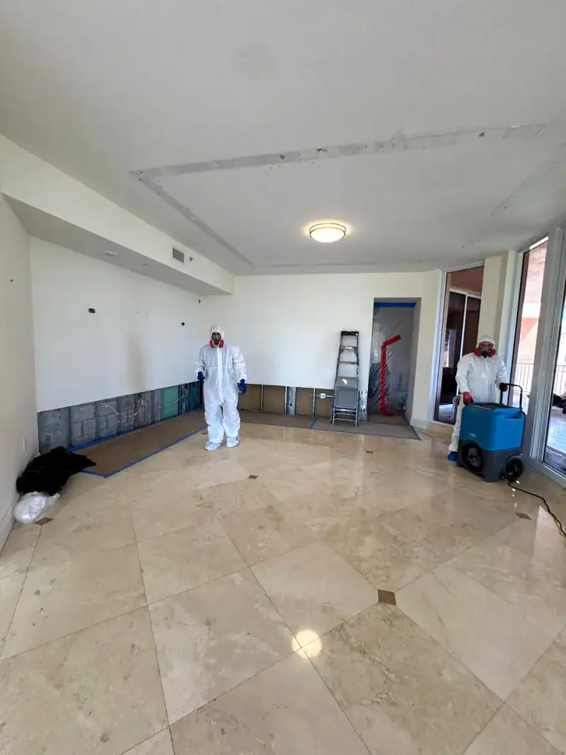 24/7 Service Pros technician inspecting water damage during a restoration job