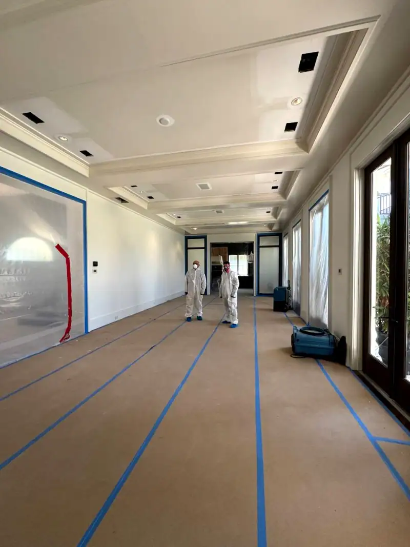 24/7 Service Pros technician inspecting water damage during a restoration job